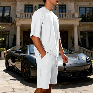Detailed view of white textured knit short sleeve shirt and shorts set worn by model outdoors.