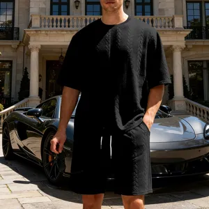 Detailed shot of men's black knit jacquard short sleeve and shorts set, casual loose fit.