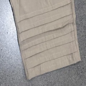 Men's casual capri pants hem pleated detail, summer holiday breathable shorts close-up view.