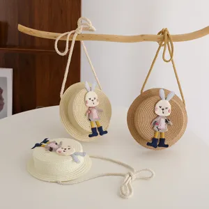 Detailed shot of kids straw woven crossbody bag with cute rabbit toy, spring summer accessory