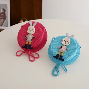 Cute kids straw crossbody bag with adorable rabbit doll, perfect for summer beach and daily wear.