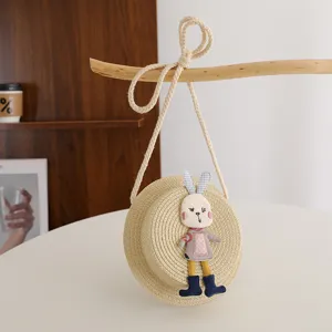 Cute children straw crossbody bag with adorable rabbit doll, perfect for spring and summer.