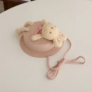 Borsa a tracolla in paglia per bambini con simpatico animale in peluche e nastro rosa, stile rotondo.