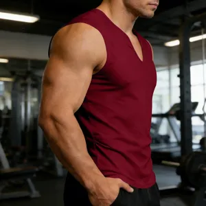 Close-up view of men's maroon V-neck fitness sleeveless vest in a modern gym training setting.