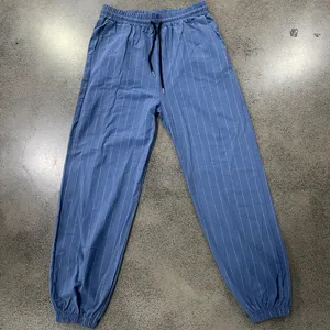 Men's blue vertical striped casual pants with elastic drawstring waist and cuffed hem.