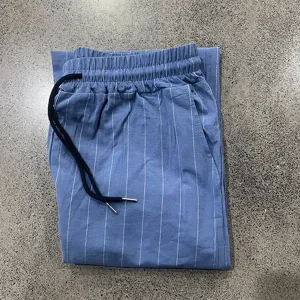 Close-up detail of blue striped casual pants featuring elastic drawstring waistband.