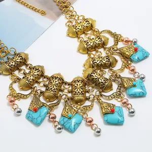 Detailed close-up of vintage bohemian multi-layer statement necklace with turquoise stones.