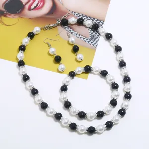 Klassisches schwarz-weisses Kunstperlen Schmuckset Halskette Armband Ohrringe fuer Damen.