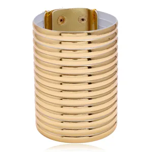 Detailed view of wide golden ribbed cuff bracelet featuring multi-ring design and snap closure.