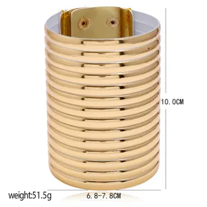Gold wide cuff bracelet detail view, layered metallic finish design, snap button closure.