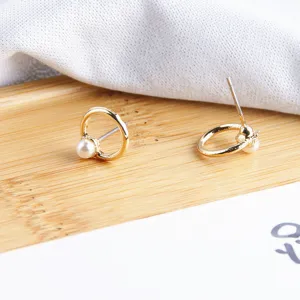 Gouden ronde parel oorknopjes detail close-up, elegante mode sieraden accessoires.