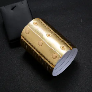 Detailed close-up of gold PU leather wide cuff bracelet featuring metallic finish texture snap buttons.