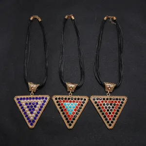 Close-up of European style multi-strand black cord necklaces with large triangle rhinestone pendants.