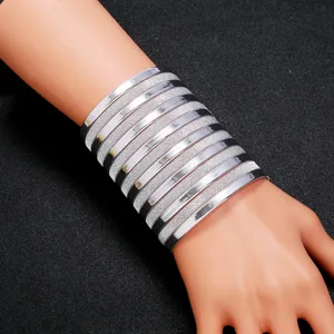 Exaggerated wide multi-layer silver metal cuff bracelet stacking fashion bangle jewelry.