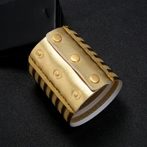 Gold metallic wide PU leather cuff bracelet with snap buttons and layered striped design detail.