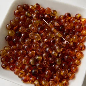 Dettaglio perline rotonde acriliche marroni, 5x6mm accessori gioielli fai da te bracciale.