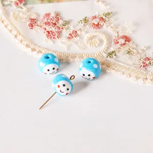 Close-up detail of blue glass smiley face polka dot beads with pins for DIY earrings.