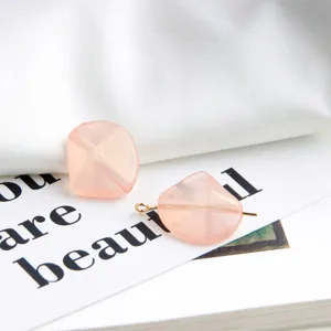 DIY handmade jewelry accessory detail pink irregular glitter bead pendant material close-up view