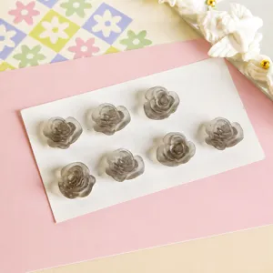 Grey matte resin rose cabochon detail shot, showing exquisite floral shape and texture.