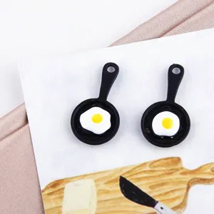Miniature simulation frying pan DIY earring charms accessory close-up detail display.