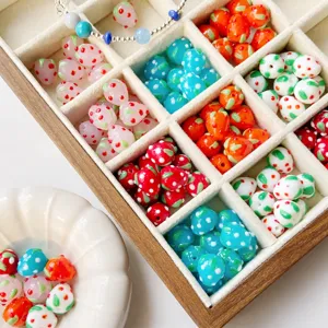 Handmade glass strawberry beads for DIY jewelry making, necklace bracelet charm crafts.
