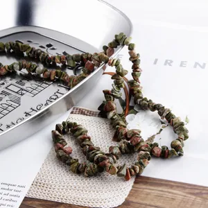 Detailed view of natural irregular stone chip beads string for DIY jewelry making and crafting.