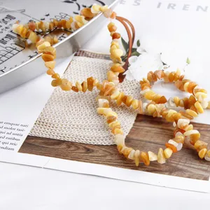 Detail view of yellow irregular acrylic stone chip beads, perfect for DIY jewelry making.