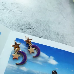 Exquisite alloy star and moon drop earrings with purple glitter design for women fashion.
