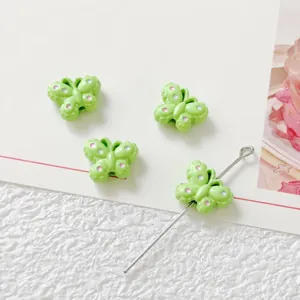 Green butterfly bead detail shot, alloy DIY jewelry accessory, close-up view of size and hole.