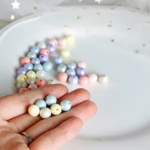 Pastel round acrylic resin beads for DIY handmade jewelry accessories, craft detailing view.
