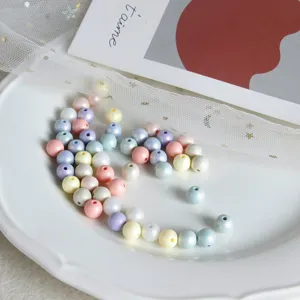 Close up of colorful pastel resin round beads for DIY jewelry making and craft accessories.