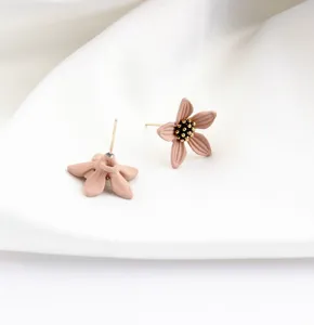 Pink painted flower stud earrings detail, elegant floral jewelry component for DIY crafting.