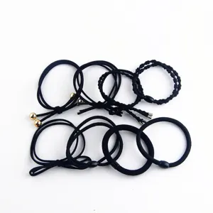 Set of black elastic hair ties with metal beads and knots, versatile minimalist ponytail holders.