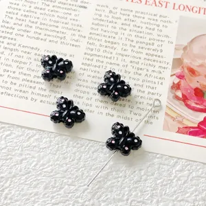 Black butterfly loose beads detail shot, small alloy beading material for DIY jewelry making.