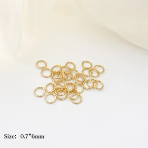 Close-up of 18K gold-plated jump rings, size 0.7x6mm, perfect for DIY jewelry making.