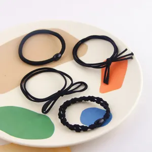 Set of four black elastic hair ties and scrunchies set for women daily styling use.
