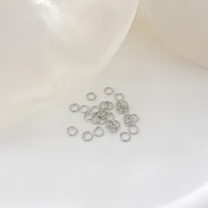 Close-up detail view of silver metal jump rings for DIY jewelry making accessories.