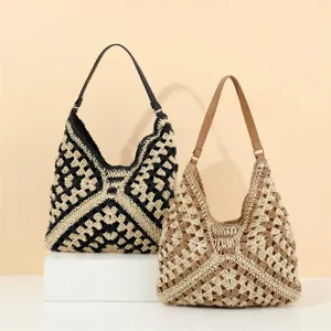 Detailed view of the handmade crochet shoulder bag showing intricate knit texture and straps.