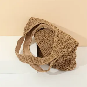 Detailed view of the handcrafted straw woven shoulder underarm bag texture and design.
