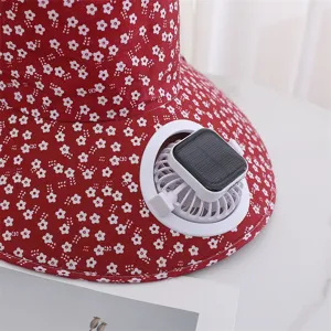 Detail view of the red floral sun hat featuring a built-in solar powered mini fan component.