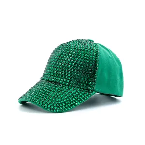 Close-up detail of the sparkling green rhinestone baseball cap brim and crystal paved panels.