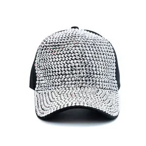 Detailed view of the sparkling rhinestone embellished black baseball cap fabric and shiny crystals.