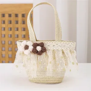 Close-up of children's mini straw woven handbag featuring lace trim and cute crochet flowers.