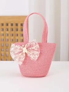 Bolso de mano de paja rosa para ninos con lazo de encaje y conejo vista frontal principal