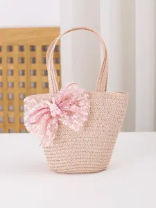 Bonito bolso de mano de paja para niños con lazo rosa y conejito para el verano.