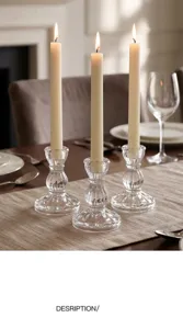 Detail view of nordic vintage striped glass candlestick holder with white candle for table decor.