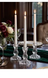 Detail shot of Nordic vertical stripe glass candlestick with candle for romantic dinner setup.