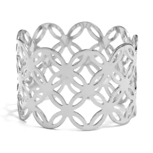 Silver metal napkin ring with hollow clover pattern for elegant table decor settings.
