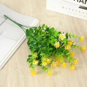 Artificial eucalyptus flower vine detail view, decorative green plant with yellow blooms for home.