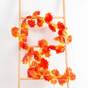 Artificial maple leaf vine for autumn home decor, fake hanging plant for wall and park decoration.